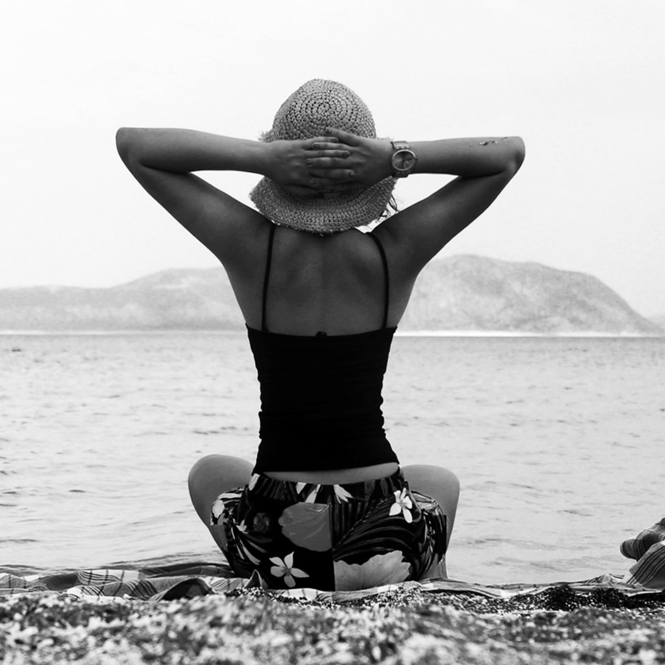 person-on-a-beach-with-their-hands-up-in-black-and-white.jpg