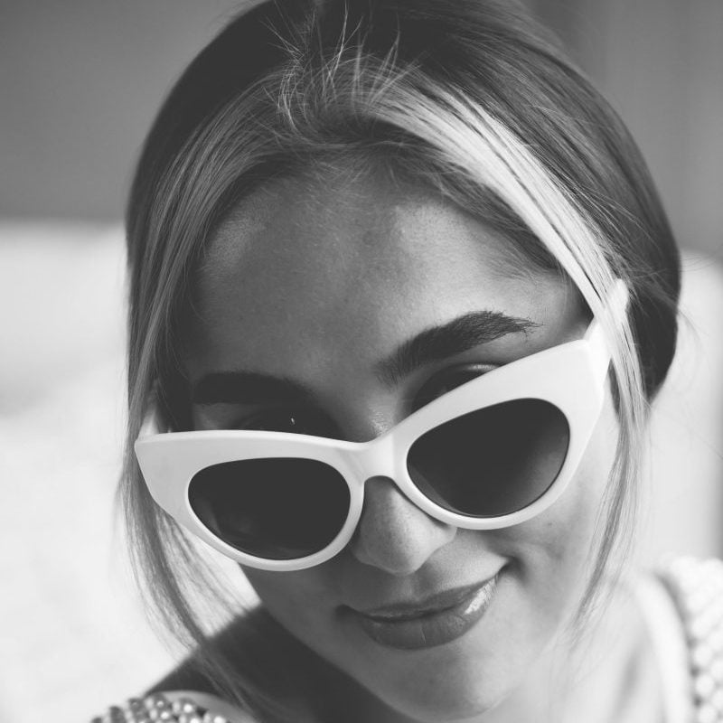 portrait-in-monochrome-of-woman-in-sunglasses-scaled-e1748606983623.jpg